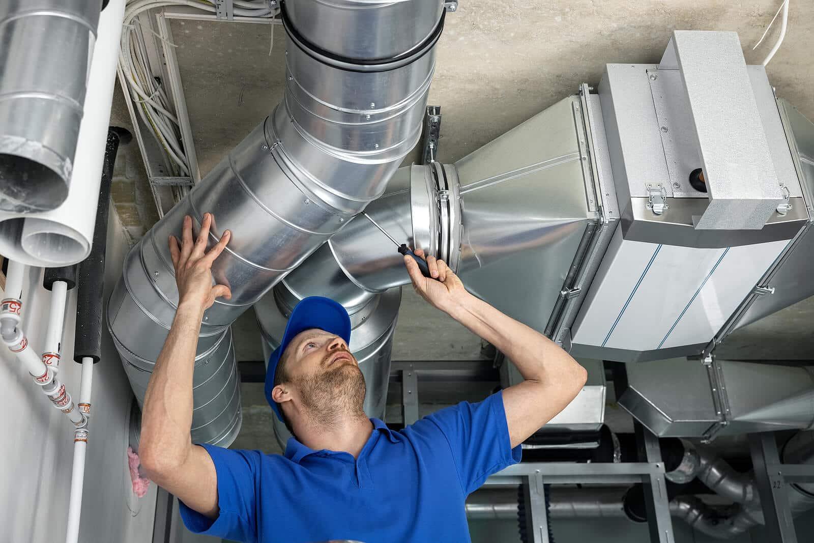 HVAC technician inspecting and repairing air ducts in Torrance