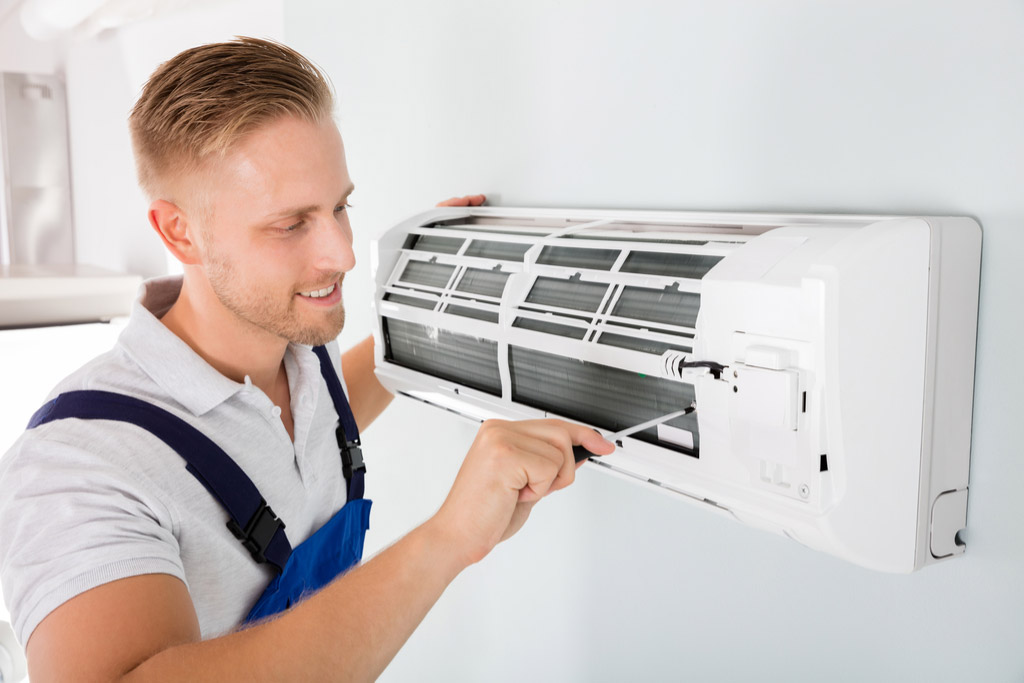 HVAC technician maintaining a ductless air conditioner in Torrance