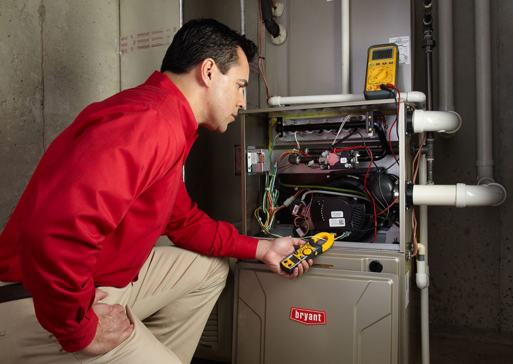 Heating technician diagnosing a furnace repair in Torrance