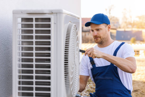 HVAC technician servicing an outdoor air conditioner in Torrance