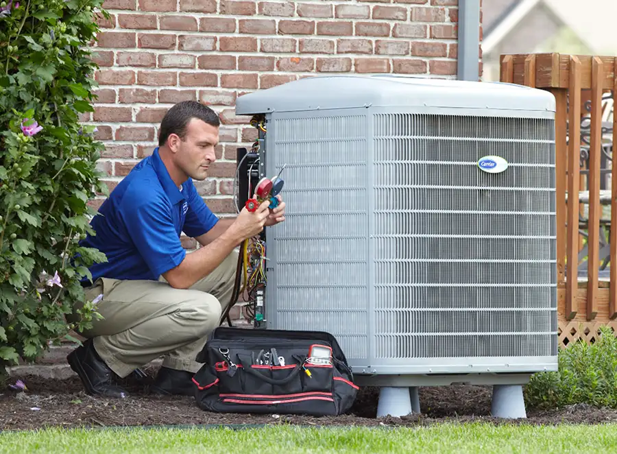 HVAC technician inspecting an outdoor AC unit in Torrance
